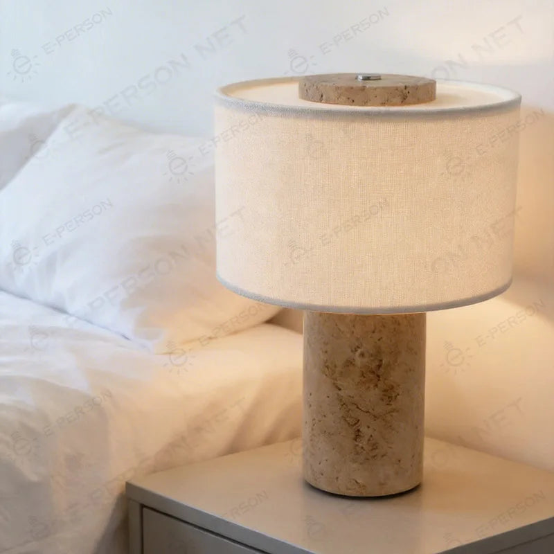 Siena cordless stone lamp glowing beside a softly styled bed