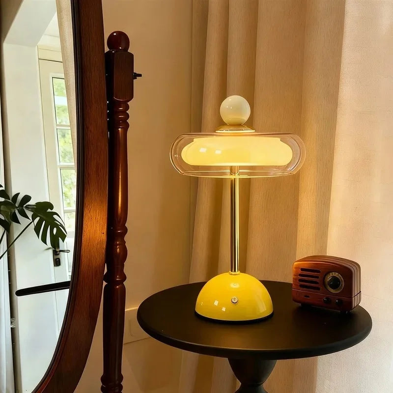 Yellow Sorrel cordless glass lamp glowing beside a vintage radio