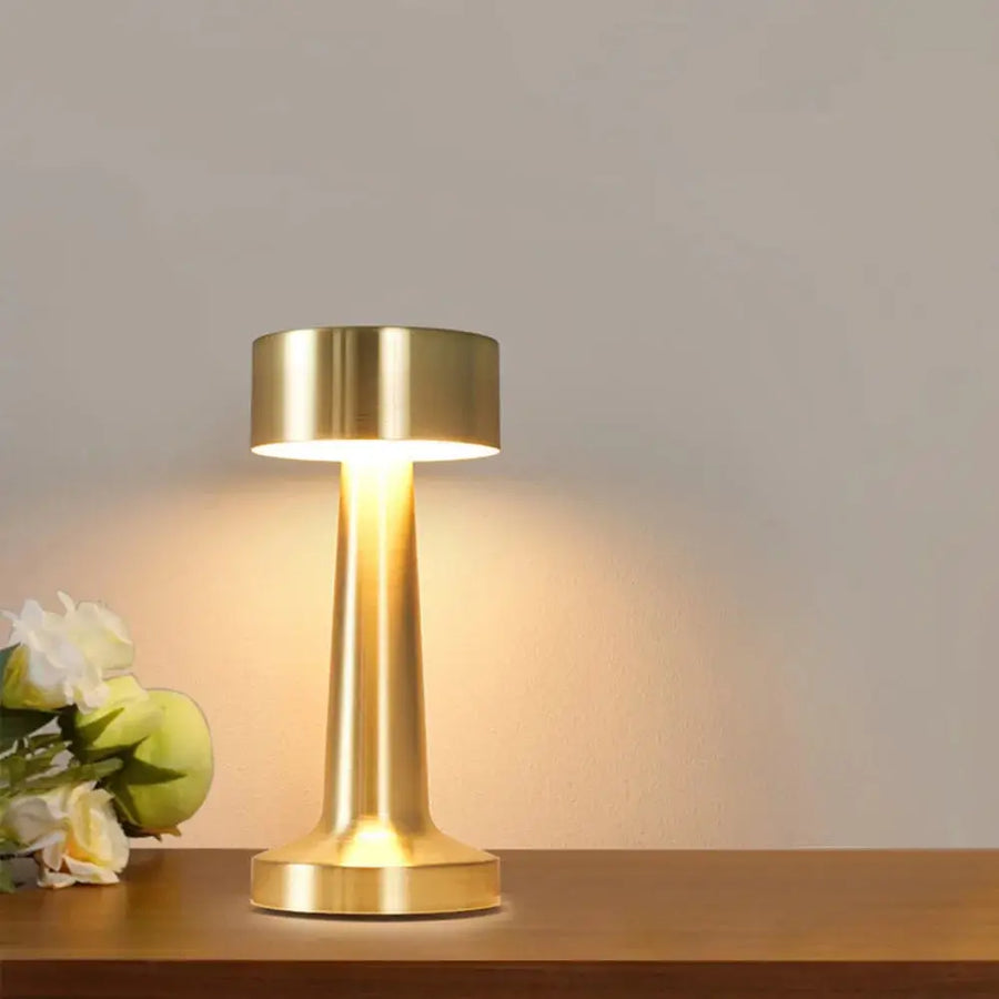 Odile cordless drum lamp in a warm gold finish