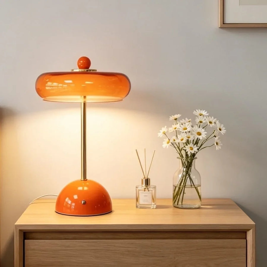 Orange Sorrel cordless glass lamp on a wood cabinet