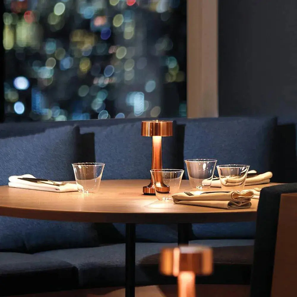 Odile copper cordless drum lamp in a restaurant booth