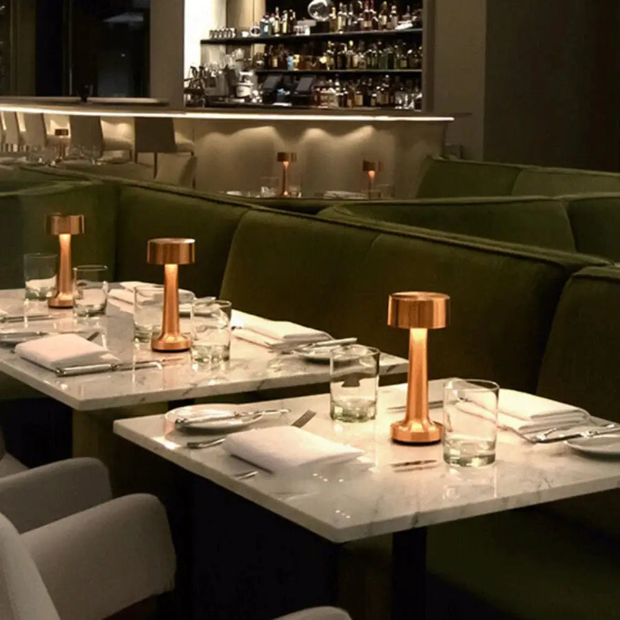 Odile copper cordless drum lamps across dining tables