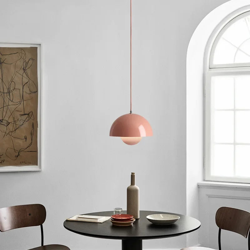 Blush Fleur metal pendant light above a round dining table