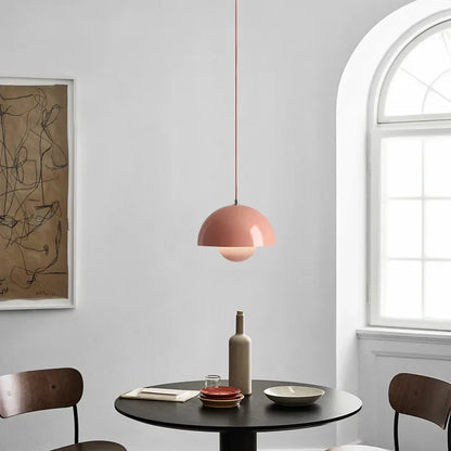 Blush Fleur metal pendant light above a round dining table