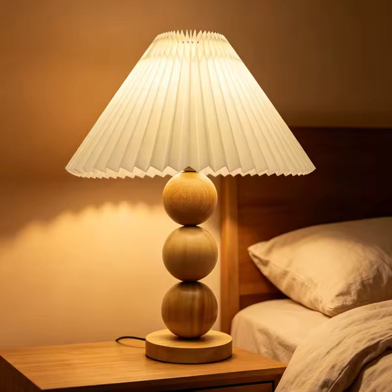 Oren natural wood lamp casting a warm pool of light
