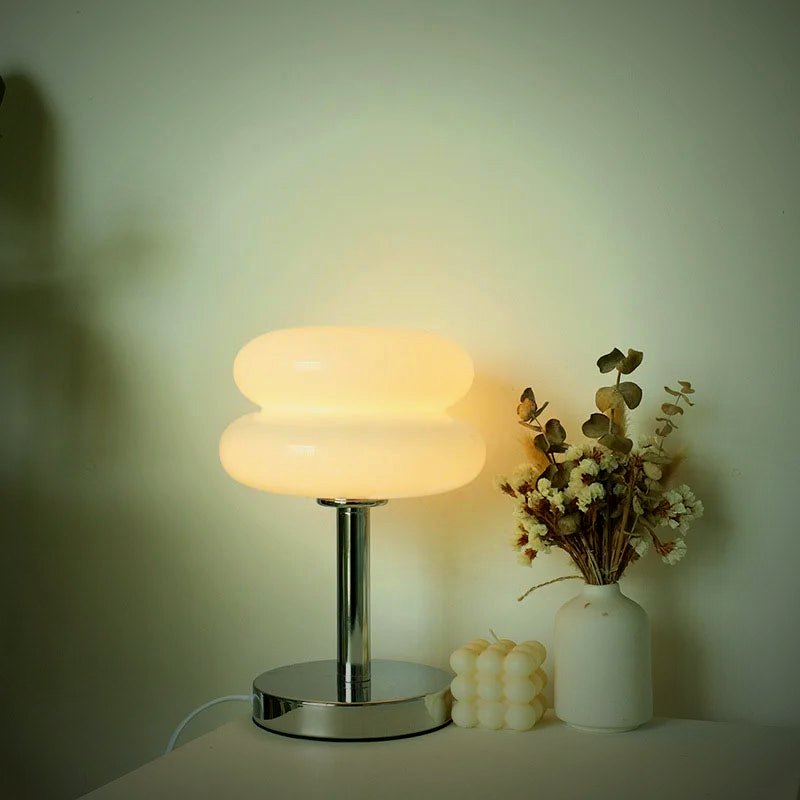Ambra white glass lamp lit in a soft interior