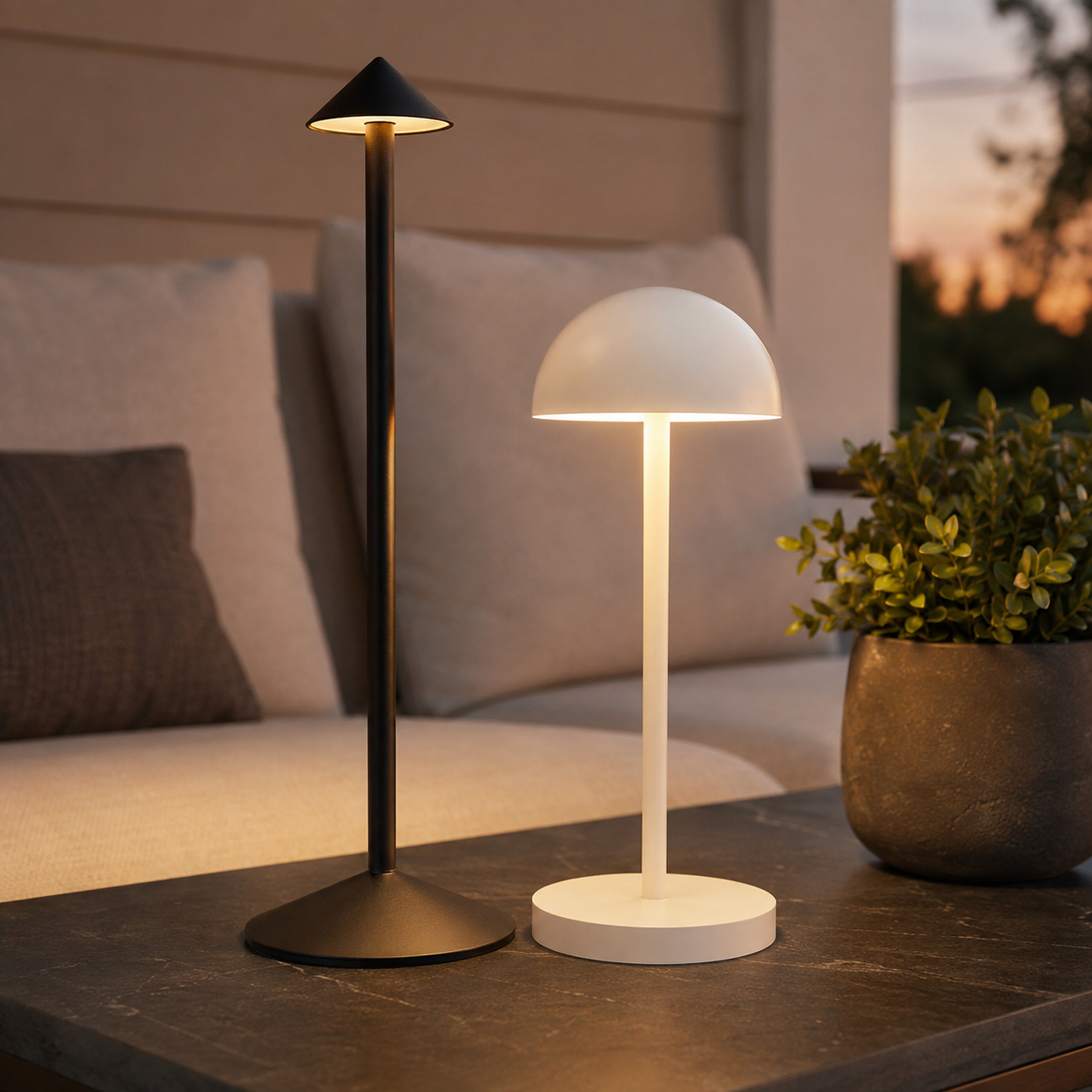 The Dusk Pair on a covered porch: the Vale tapered cone lamp beside the Marin rounded dome lamp, both lit at dusk