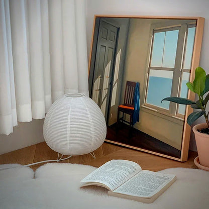 Kana rice-paper lantern table lamp beside a reading corner