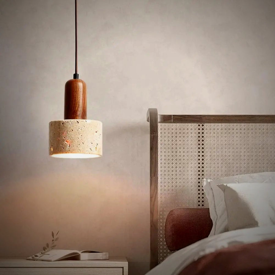 Sena travertine drum pendant beside a bed