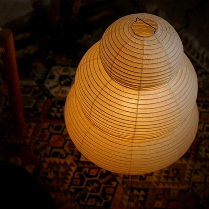 Close view of the Mochi lamp's three glowing rice-paper tiers