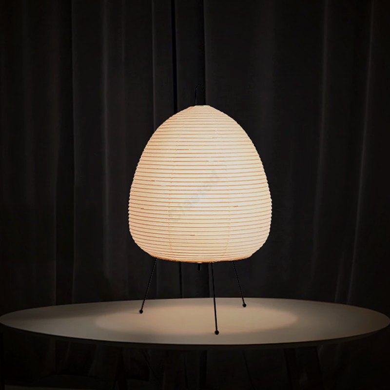 Lumae Yumi paper lantern lamp glowing on a round table