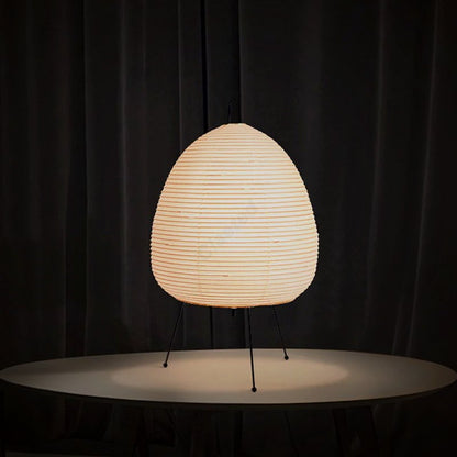 Lumae Yumi paper lantern lamp glowing on a round table