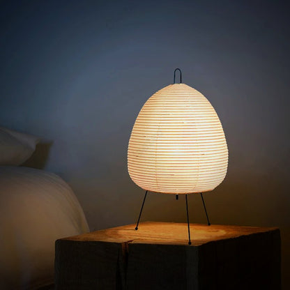 Lumae Yumi paper lantern lamp beside a bed